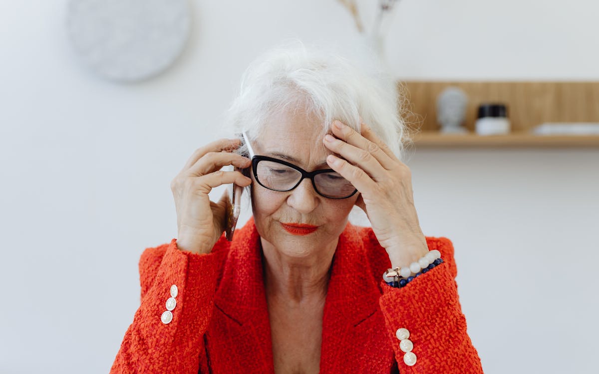 Senior woman concerned during a phone call, illustrating 2026 Medicare scam awareness