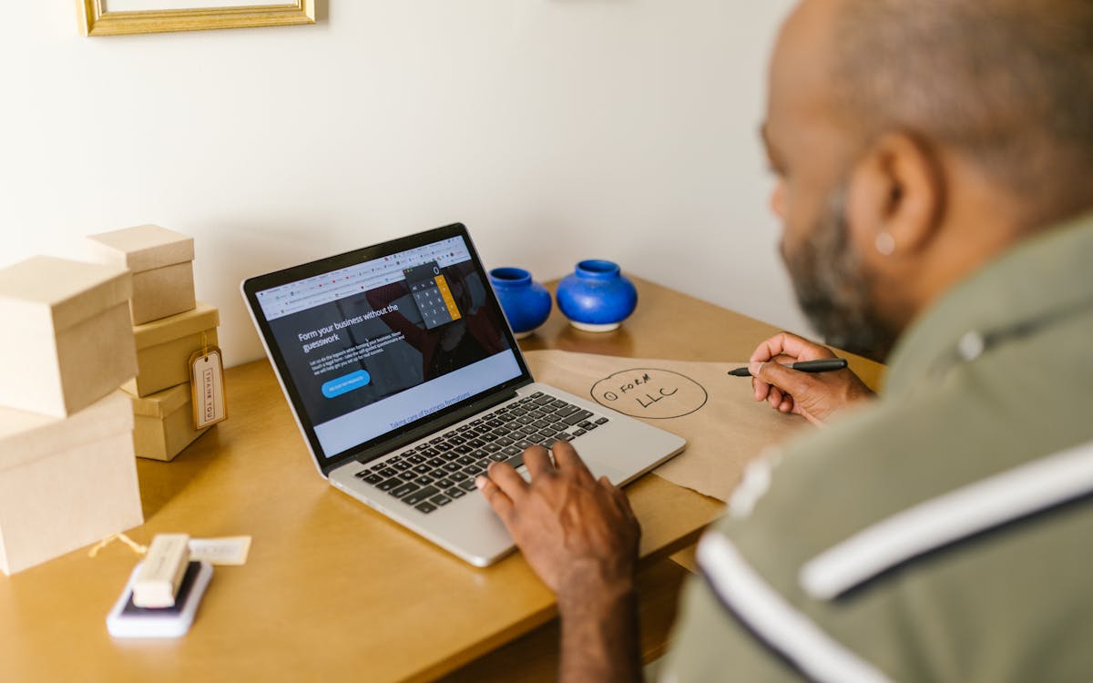 Entrepreneur reviewing 2026 health insurance coverage options on a laptop