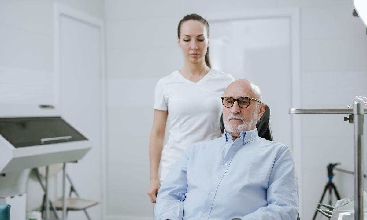 Senior patient discussing care and out-of-pocket costs with a doctor in a Florida medical clinic